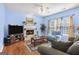 Cozy living room with hardwood floors, fireplace, and large windows at 3867 Summer Kitchen Way, Lilburn, GA 30047