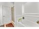 Clean bathroom features a standalone soaking tub and separate shower at 155 Stayman Park, Fayetteville, GA 30215