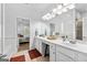 Bright bathroom vanity with double sinks, large mirror, and doorway view into the bedroom at 155 Stayman Park, Fayetteville, GA 30215