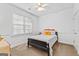 Bright bedroom with a ceiling fan, a black bed frame and white walls at 155 Stayman Park, Fayetteville, GA 30215