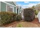 Exterior home with an American flag, porch, and lush shrubs adorning the property at 155 Stayman Park, Fayetteville, GA 30215