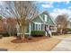 Charming green home with well-maintained landscaping, a sidewalk, and a cozy, inviting appeal at 155 Stayman Park, Fayetteville, GA 30215