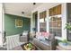 Cozy front porch with ample seating, green siding, and decor for relaxation and enjoyment at 155 Stayman Park, Fayetteville, GA 30215