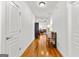 Bright hallway with hardwood floors that provides a glimpse into the living room at 155 Stayman Park, Fayetteville, GA 30215