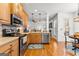 Modern kitchen features wooden cabinets, stainless steel appliances, and a backsplash at 155 Stayman Park, Fayetteville, GA 30215