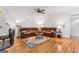 Spacious living room features hardwood floors, a ceiling fan, and a large leather sectional sofa at 155 Stayman Park, Fayetteville, GA 30215