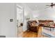 Cozy living room leading into the main bedroom with hardwood floors and comfortable seating at 155 Stayman Park, Fayetteville, GA 30215