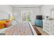 Inviting bedroom with bright sunny window, vintage nightstand, and colorful bedding at 155 Stayman Park, Fayetteville, GA 30215