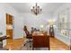 Office with wood floors, large desk, chandelier, and natural light from window at 155 Stayman Park, Fayetteville, GA 30215