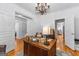 Spacious office with wood floors, chandelier and open doorway to other rooms at 155 Stayman Park, Fayetteville, GA 30215
