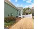 Backyard view with manicured lawn, greenery, and a white picket fence at 155 Stayman Park, Fayetteville, GA 30215