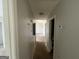 Hallway needing some repairs leads into a living room in this house at 133 Dove Lndg, Social Circle, GA 30025