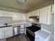 Kitchen featuring white cabinets, stainless steel appliances, and a sleek countertop at 133 Dove Lndg, Social Circle, GA 30025