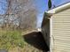 Home's side yard featuring vinyl siding, rain gutters, and access to the backyard at 133 Dove Lndg, Social Circle, GA 30025