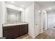 Bathroom featuring a double vanity with granite countertop and wood-look flooring at 106 Cowpen Ct, Walnut Grove, GA 30052