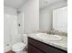 Bathroom featuring a shower, toilet, granite countertop, and white door at 106 Cowpen Ct, Walnut Grove, GA 30052