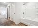 Bathroom with a clean white tub/shower and vinyl flooring at 106 Cowpen Ct, Walnut Grove, GA 30052
