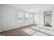 A sunny bedroom featuring a large window that offers a view of the surrounding neighborhood at 106 Cowpen Ct, Walnut Grove, GA 30052