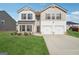 Inviting two-story home featuring a two-car garage, manicured lawn, and a mix of brick and siding exterior at 106 Cowpen Ct, Walnut Grove, GA 30052