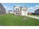 Two-story home with a well-maintained lawn, long driveway, and a mix of siding and brick accents at 106 Cowpen Ct, Walnut Grove, GA 30052