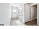 Hallway leads to the front door, with hardwood flooring and a view of an adjacent room at 106 Cowpen Ct, Walnut Grove, GA 30052