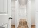 Hallway with hardwood-style floors and white doors at 106 Cowpen Ct, Walnut Grove, GA 30052