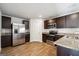 Modern kitchen featuring stainless steel appliances, granite countertops, and wood-look floors at 106 Cowpen Ct, Walnut Grove, GA 30052