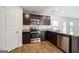 Modern kitchen with stainless steel appliances, granite countertops, and stylish wood flooring at 106 Cowpen Ct, Walnut Grove, GA 30052