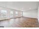 Spacious living room with wood-look flooring and lots of natural light at 106 Cowpen Ct, Walnut Grove, GA 30052