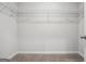 Walk-in closet featuring carpeted floor and metal rack shelving for optimal storage solutions at 604 Clark Lake Estates Dr, Grayson, GA 30017