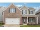 Charming two-story brick home features a two-car garage, neutral colors, and professionally landscaped yard at 604 Clark Lake Estates Dr, Grayson, GA 30017