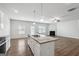 Open kitchen, granite island countertop, stainless steel appliances, and a view to the living area with a fireplace at 604 Clark Lake Estates Dr, Grayson, GA 30017