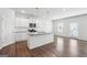 Modern kitchen features white cabinets, granite countertops, stainless appliances, and hardwood floors at 604 Clark Lake Estates Dr, Grayson, GA 30017