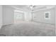 Large bedroom with multiple windows, ceiling fan, and neutral carpet at 604 Clark Lake Estates Dr, Grayson, GA 30017