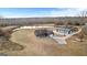 Aerial view showcasing a modern home with a pond and a large outbuilding, surrounded by an expansive, well-manicured yard at 10 Last St, Moreland, GA 30259