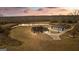 Aerial view of the home and the matching three-bay garage and pond at 10 Last St, Moreland, GA 30259