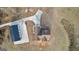 Overhead view of a home with an outbuilding and a long driveway, set on a spacious lot with mature trees at 10 Last St, Moreland, GA 30259