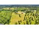 Another aerial view of the property with pond, home, and matching three-bay garage at 10 Last St, Moreland, GA 30259