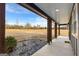 Covered porch with exposed beams overlooks vast backyard at 10 Last St, Moreland, GA 30259