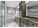 Bright bathroom featuring marble floors, a double sink vanity, a glass shower, and a soaking tub at 10 Last St, Moreland, GA 30259