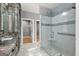 Bright bathroom featuring marble floors, a double sink vanity, a glass shower, and a walk-in closet at 10 Last St, Moreland, GA 30259