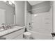 Bathroom features a granite-topped vanity, white cabinets, and tub-shower combination at 10 Last St, Moreland, GA 30259