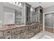 Bright bathroom featuring marble floors, double sink vanity, with a glass shower and a soaking tub at 10 Last St, Moreland, GA 30259