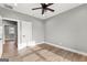 Bedroom featuring gray walls, hardwood floors, ceiling fan, and white doors and trim at 10 Last St, Moreland, GA 30259