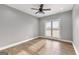 Bedroom featuring gray walls, hardwood floors, ceiling fan, and bright natural light at 10 Last St, Moreland, GA 30259