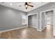 Cozy bedroom featuring wood floors, a bright window, and a ceiling fan at 10 Last St, Moreland, GA 30259