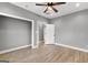 Bedroom featuring gray walls, hardwood floors, ceiling fan, and white doors and trim at 10 Last St, Moreland, GA 30259