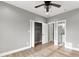 Bedroom featuring gray walls, hardwood floors, ceiling fan, closet, and attached bathroom at 10 Last St, Moreland, GA 30259
