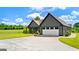 Front view of the craftsman home with a side entry two-car garage at 10 Last St, Moreland, GA 30259