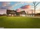 Beautiful exterior of a modern home with a large yard and matching three-bay garage at 10 Last St, Moreland, GA 30259